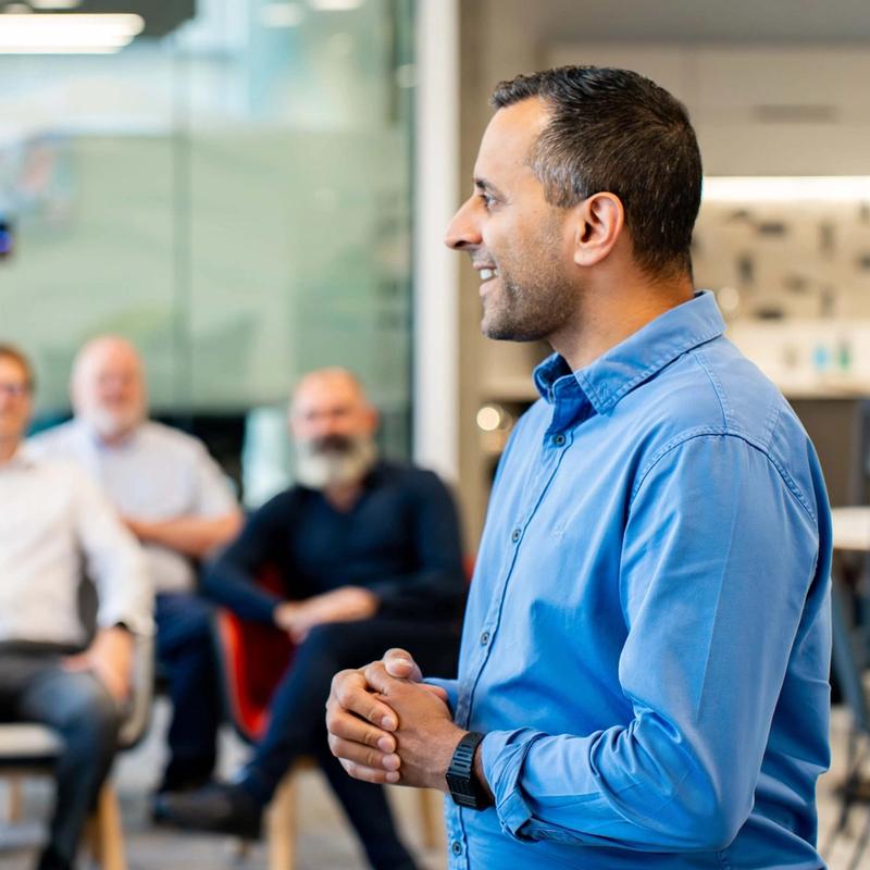 Allam Zia Presenting to a small audience on behalf of the Management Consulting team