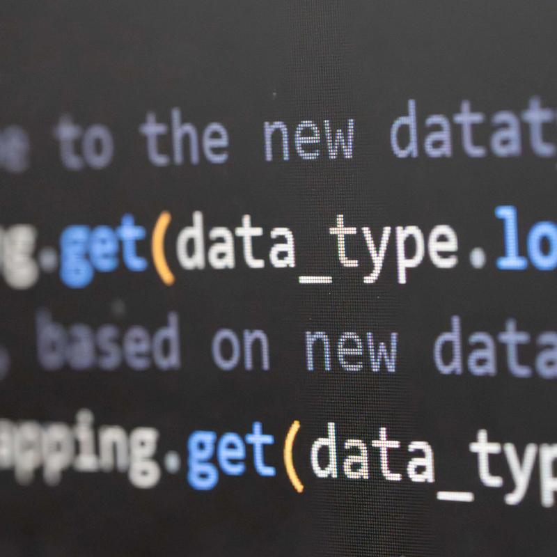 A close-up of a monitor displaying computer code