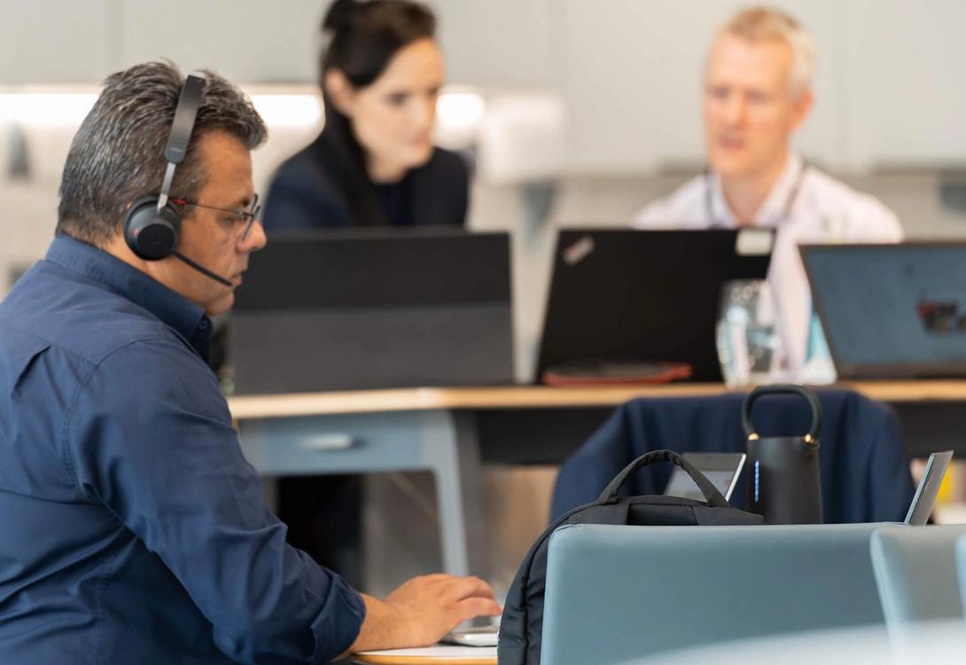 People working remotely in the C5 hub on their laptops and tablets