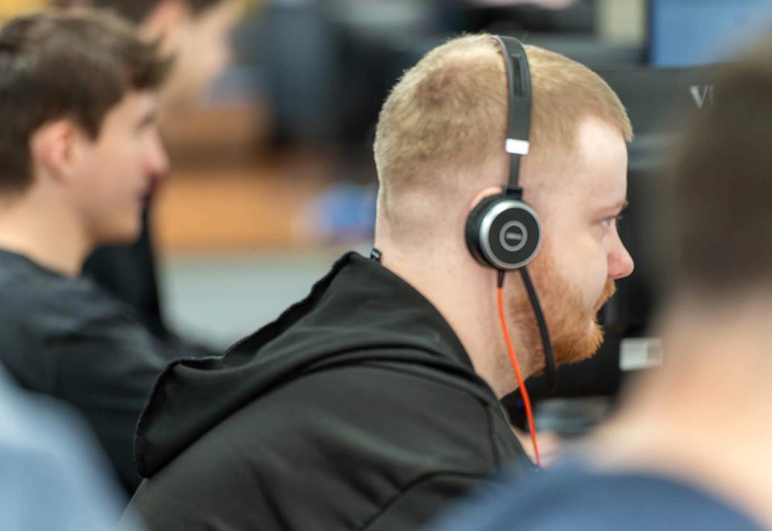 A row of C5 IT Services Team Members working at their desks in the C5 office