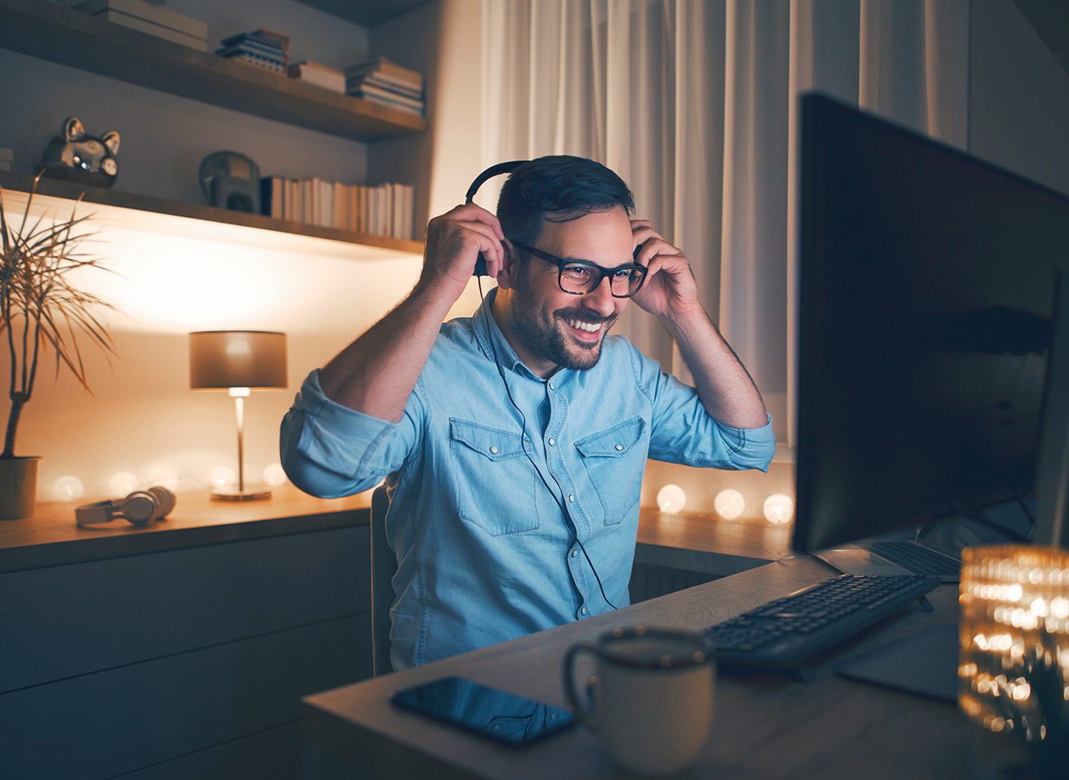 Man working at home wearing headphones