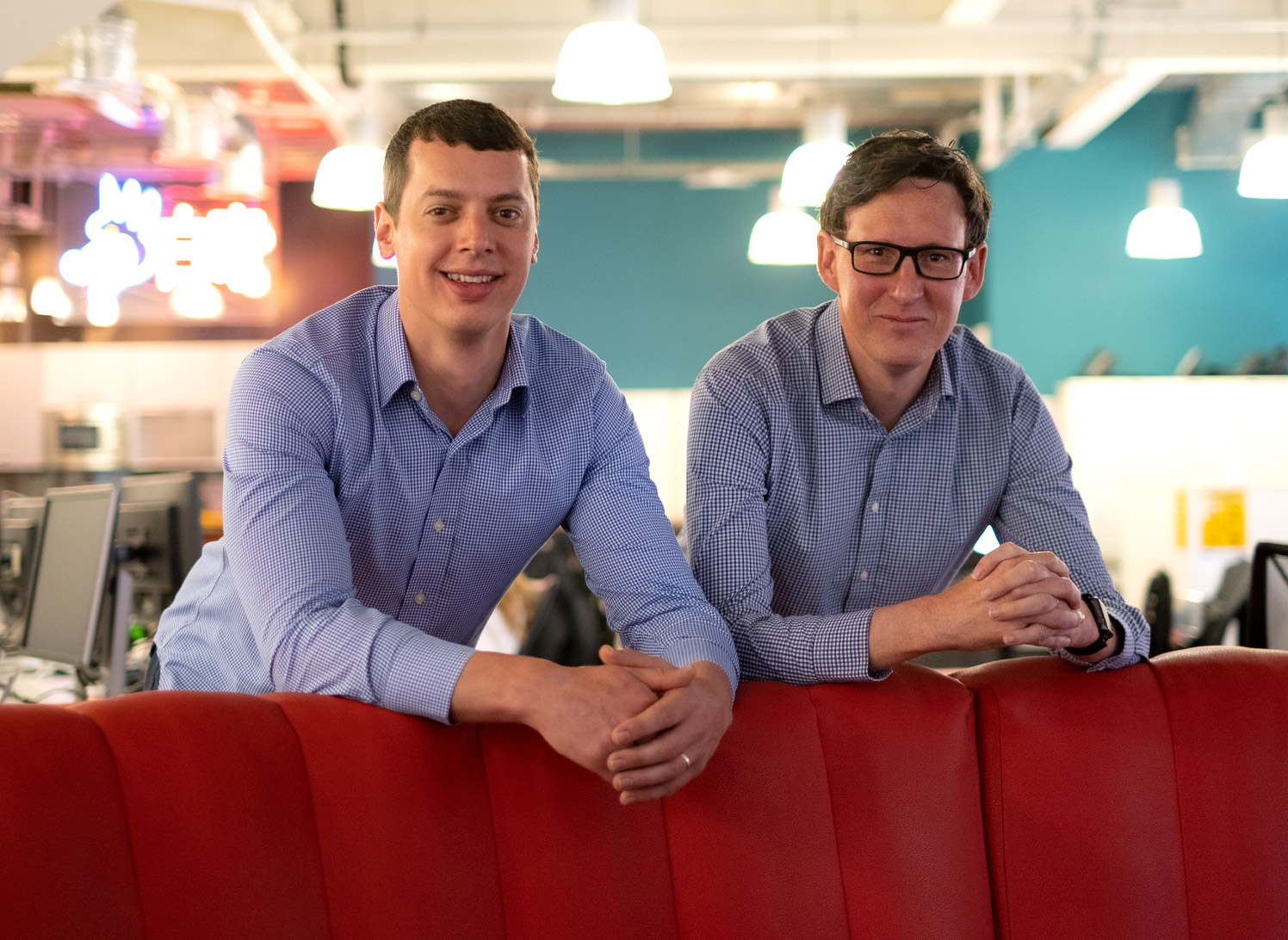 Andy HR and Joel G posing casually at the C5 office for their senior promotions