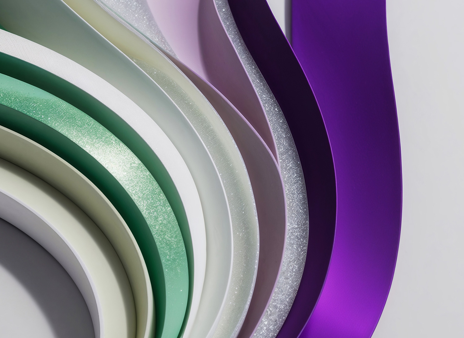 Green and Purple Ribbons depicting the abstract concept of Data Fabric vs Data Warehouse